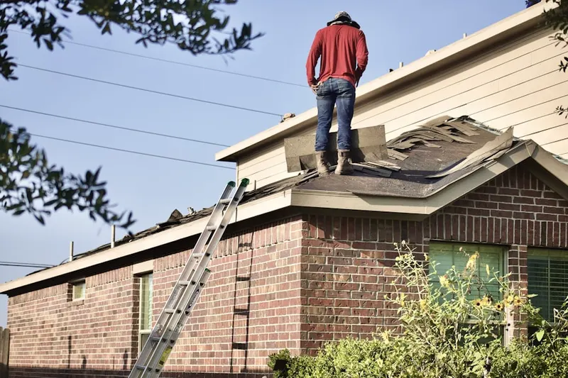 Professional roofer working on a residential roof in Shirrells
